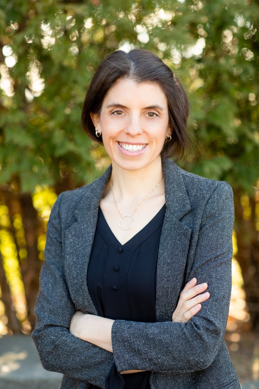 A woman smiles for the camera.