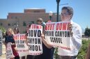 Demonstrators at a news conference make a show of support for parents suing the Provo Canyon School on June 15, 2026.