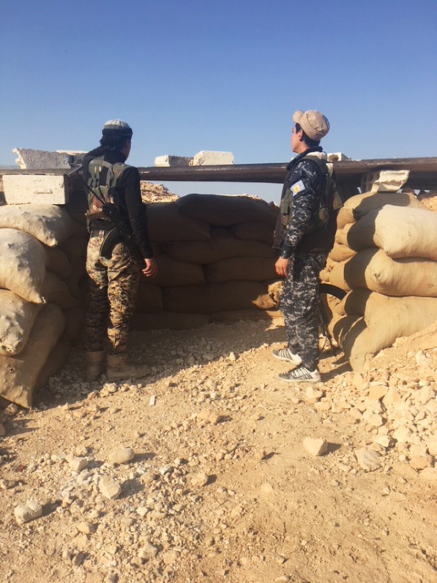 Syrian Democratic Forces stand guard at an observation post outside Manbij- near the front-line with Turkish backed forces.