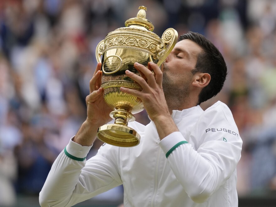Serbia's Novak Djokovic kisses the winners trophy after he defeated Italy's Matteo Berrettini in the men's singles final at Wimbledon on Sunday.