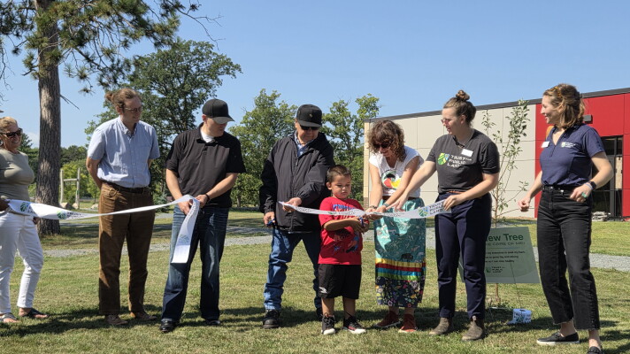 Representatives of the Red Lake Tribal Council, Endazhi-Nitaawiging Charter School and Trust for Public Land cut the ribbon for a new natural playground during a ceremony on Aug. 25, 2026.