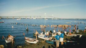 Traditionally, swimmers at "The Swim" were followed across the bay by row boats. Kayaks became more popular in the 2000s.