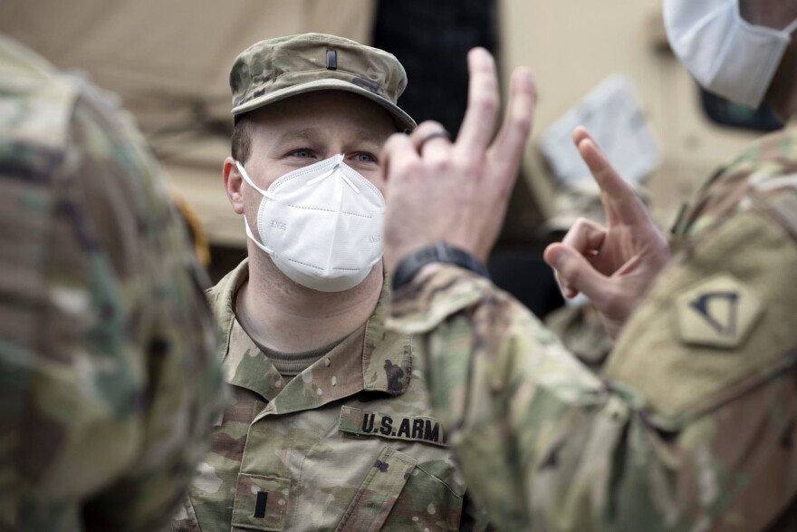 A Massachusetts National Guard soldier wears a protective mask while on duty at a food distribution site outside Chelsea City Hall in April 2020. (Michael Dwyer/AP file photo)