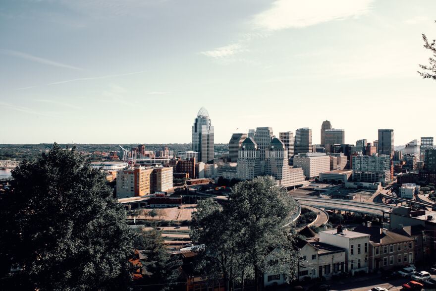 view of the cincinnati buildings and roads and trees from hillside vantage point