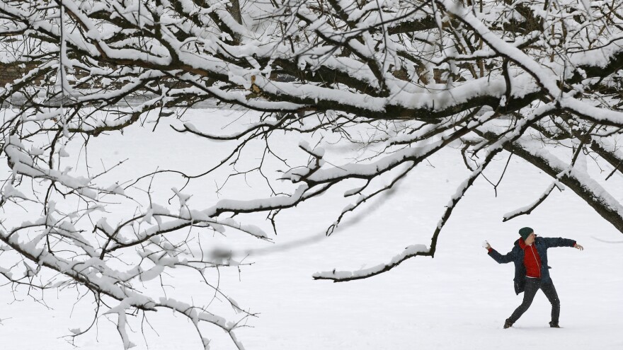 A man throws a snowball Wednesday in Baltimore as a spring nor'easter hit the region with strong winds and a foot or more of snow in some parts.