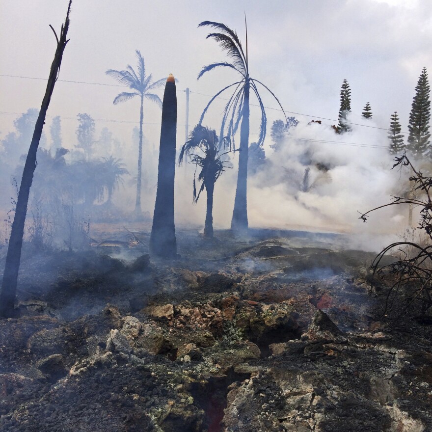 This photo provided by the U.S. Geological Survey shows severe ground cracks associated with what's known as Fissure 14 beneath a burned-out landscape in Leilani Estates near the town of Pahoa, Hawaii, on Wednesday.