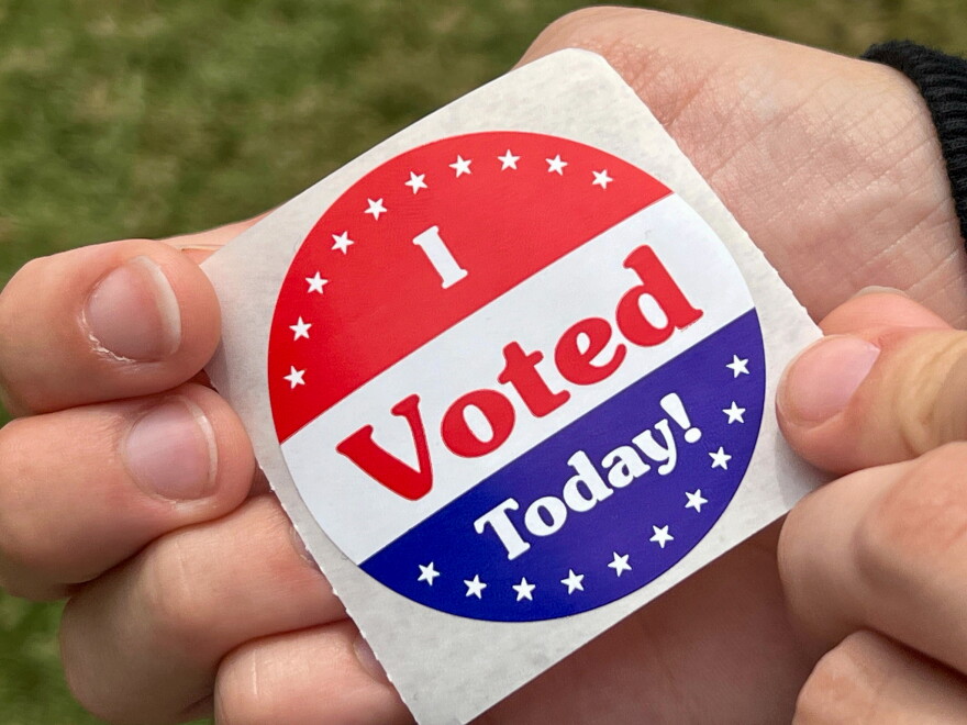 A first-time voter displays their voting sticker on August 4, 2026.