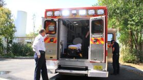 Alachua County Fire Rescue Department Chief William Northcutt speaks with a team of emergency medical technicians outside the Fire Rescue Headquarters Tuesday. Northcutt said the department was able to hire three additional employees following Alachua County's interlocal agreement with Bradford County. (Nate Phillips/WUFT News)