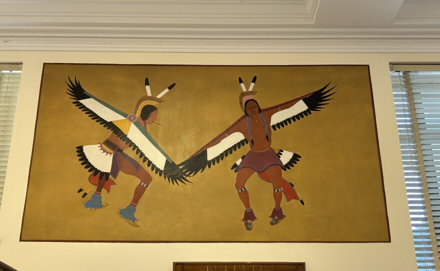 Kiowa artist Stephen Mopope painted murals in what is now the Anadarko Post Office in 1937. During the time Mopope painted this mural, Native American religious ceremonies and dances were outlawed. Depicting them, like things shown here was risky. It wasn’t until 1978 that Native people had the right to practice their religion openly.