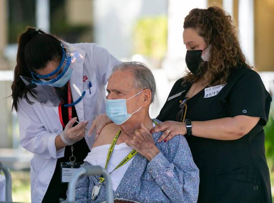 Antonio Castro receives the Pfizer-BioNTech COVID-19 vaccine from Walgreens Pharmacy Intern Erika Blanco, 24, at The Palace Renaissance & Royale, an assisted living facility in Kendall, on Wednesday, January 13, 2021.