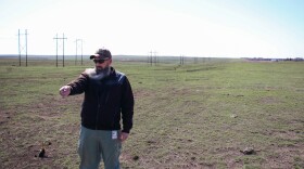 Archie Stone, the wildland coordinator for the Borger Fire Department, points to where the Windy Deuce fire stopped next to a 2023 prescribed burn line outside the city.