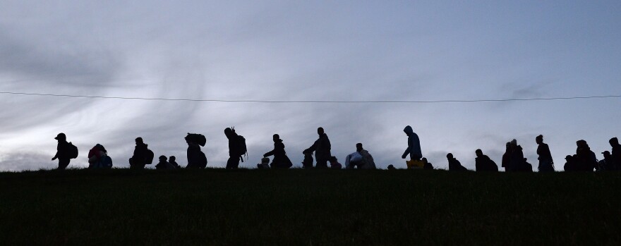 German police guide a group of migrants after they crossed the border between Austria and Germany near Passau, Germany, on Wednesday. The massive influx of migrants this year has stirred debate about Europe's open borders policy.