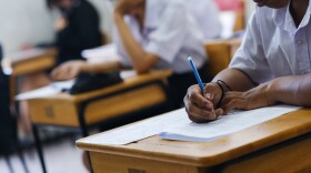 Assessment examination of high school students dressed in uniform.