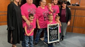 Lisa and Scott Skeate pose with their family following the adoption proceedings in Williamson County.