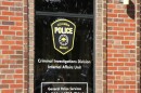 A close up of the window of the Columbia Police Department with a sign that reads "Criminal Investigations Division Internal Affairs Unit"