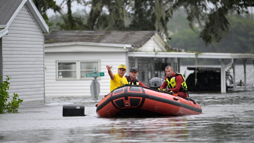 First responders with Orange County Fire Rescue use a boat to rescue a resident in a flooded neighborhood in the aftermath of Hurricane Ian, Thursday, Sept. 29, 2022, in Orlando.