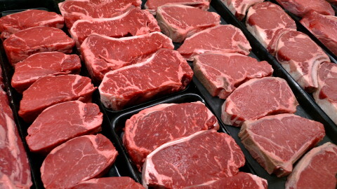 Rows of raw steak in a deli cabinet.
