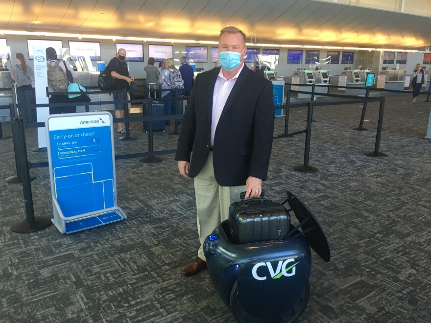 CVG Chief Innovation Officer Brian Cobb tries out Gita the robot.
