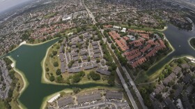 Housing developments are seen amid artificial lakes on the western side of Miami, Friday, May 17, 2024, during a flight donated by LightHawk over parts of the vast Everglades ecosystem in southern Florida. (AP Photo/Rebecca Blackwell)