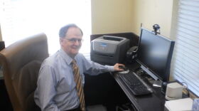Lee Todd at his desk after turning off his computer for the last time as president