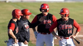 Incoming Peninsula Oilers Baseball Club Head Coach Dave Dawson (second from left) talks to players talk during a game in 2024.