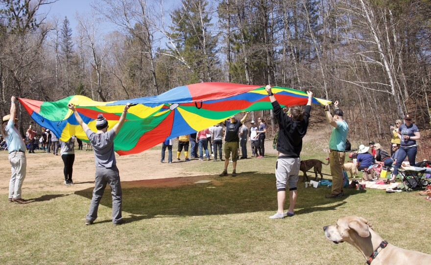 Playing with a parahute at the kickball game