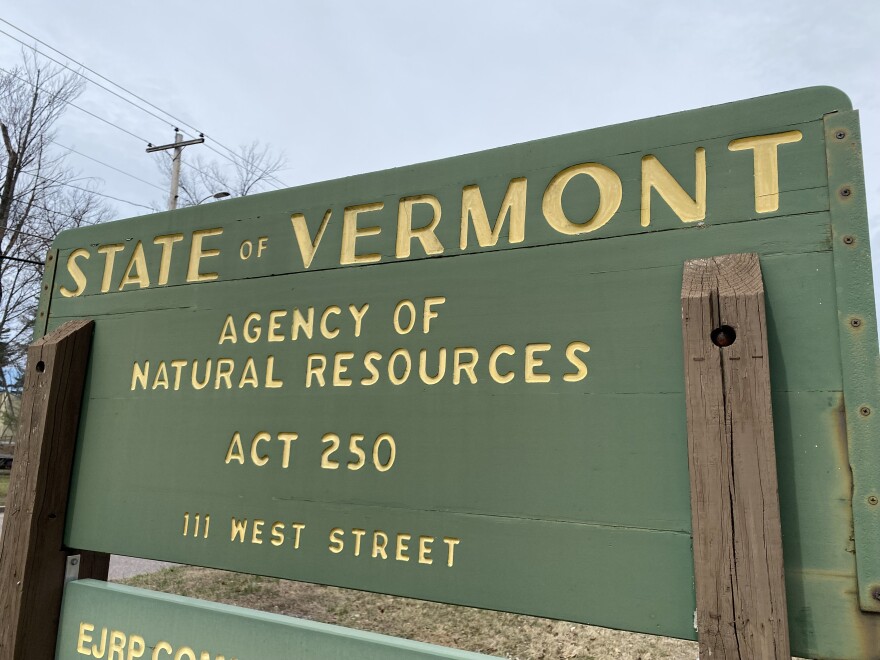 A green sign with yellow lettering reads "State of Vermont Agency of Natural Resources, Act 250"