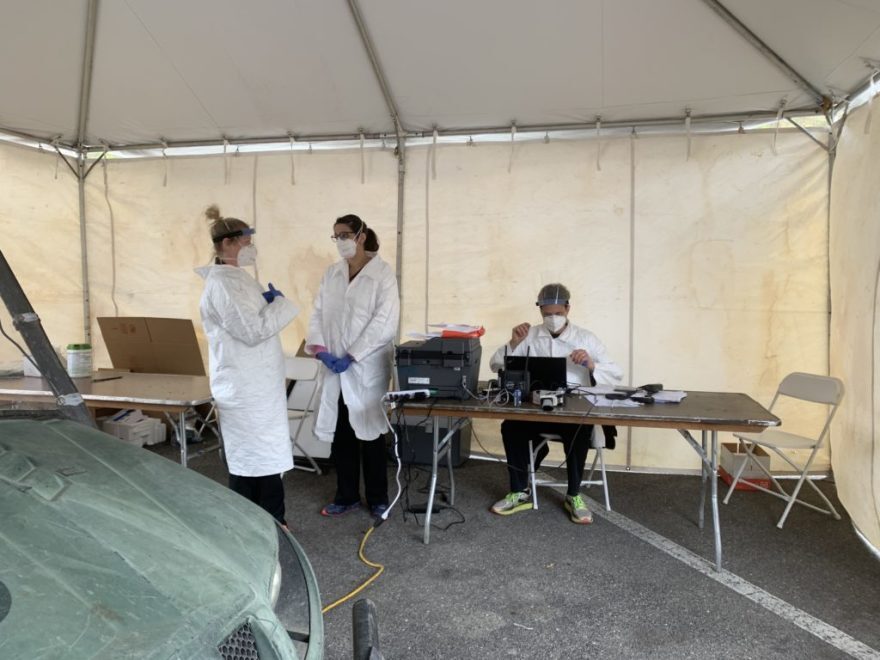 Health care workers wait for patients at a Pikeville, KY coronavirus testing site.