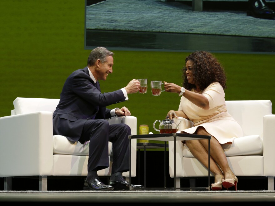Howard Schultz, left, chairman and CEO of Starbucks Coffee Company, clinks tea cups with Oprah Winfrey, right, to announce their partnership to offer Teavana Oprah Chai tea.