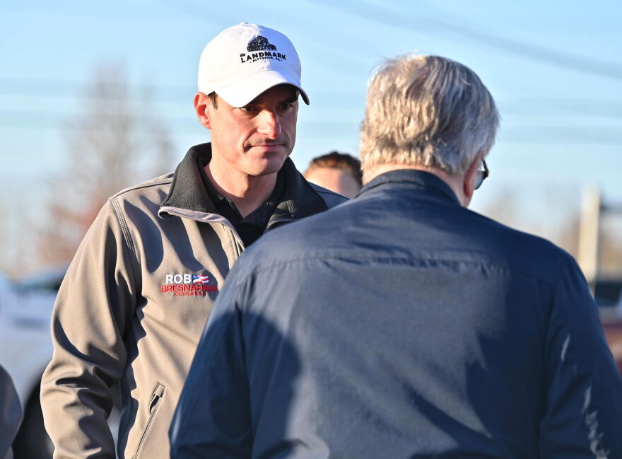 Bresnahan waits in line among potential constituents to cast his vote.