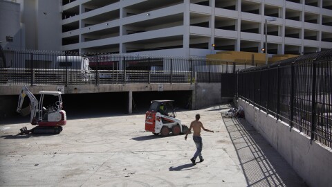A homeless man watches as workers clear a homeless encampment in a storm drain near a casino in Las Vegas on Thursday, May 26, 2022. Hundreds of homeless people die in the streets each year from the heat, in cities around the U.S. and the world. The ranks of homeless have swelled after the pandemic and temperatures fueled by climate change soar. (AP Photo/John Locher)
