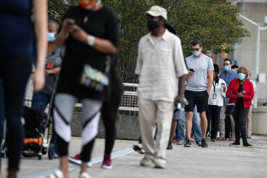 Voters line up outside of State Farm Arena, Georgia's largest early voting location, for the first day of early voting in the general election on October 12, 2020 in Atlanta, Georgia. (Jessica McGowan/Getty Images)