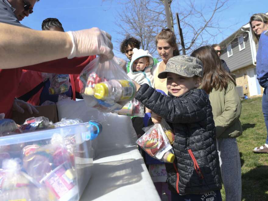 Kids whose schools are shut down in Anne Arundel County, Md., receive food in Annapolis as part of a program to ease the burden of feeding students while schools are closed because of the coronavirus. President Trump told Americans to "engage in schooling from home when possible" on Monday.