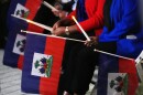 People hold Haitian flags and candles during a vigil at the Little Haiti Cultural Complex in North Miami after a federal judge blocked the Trump administration from ending TPS for Haitians, Tuesday, Feb. 3, 2026.