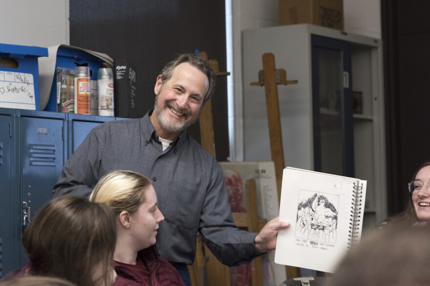 Leigh Rubin, cartoonist-in-residence at RIT, visits with students in a medical illustration class.