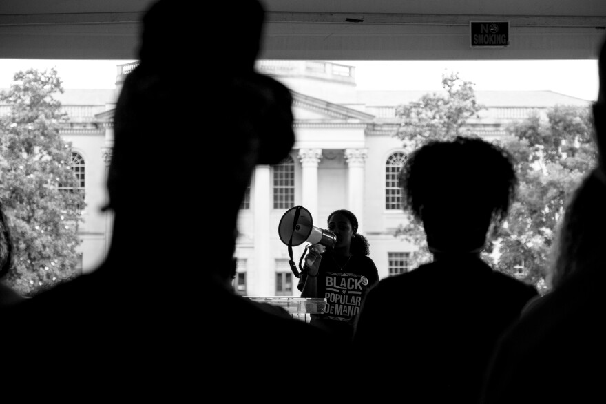 Julia Clark, vice president of the Black Student Movement at the University of North Carolina at Chapel Hill, leads a demonstration on campus to protest the university decision not to give Nikole Hannah-Jones tenure. Their demands included tenure for Hannah-Jones, who was later offered tenure but declined, more diversity on the board of trustees, a memorial for James Cates Jr., protection for the Unsung Founders Memorial and safety for Black students on campus.