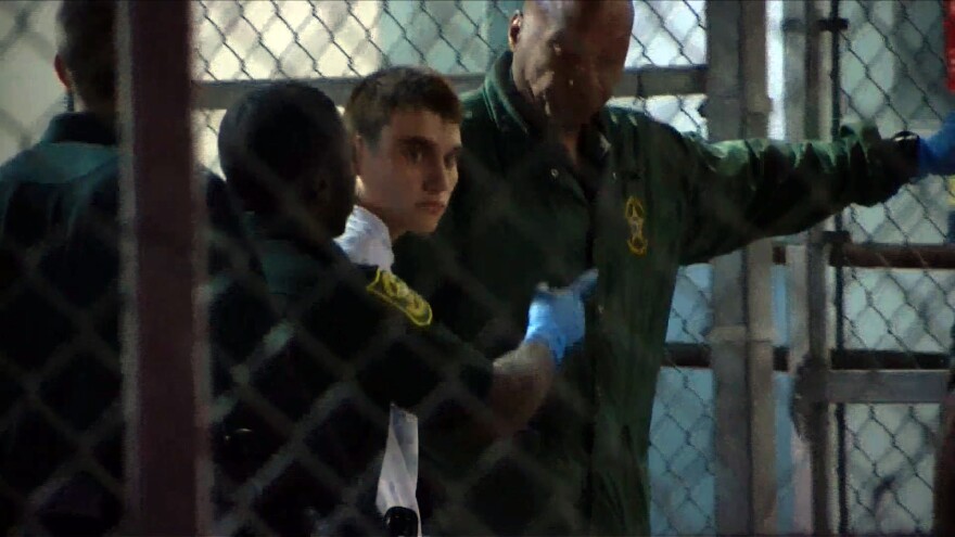 Suspect Nikolas Cruz, 19, is escorted by law enforcement at the Broward County jail in Fort Lauderdale, Fla., on Thursday.