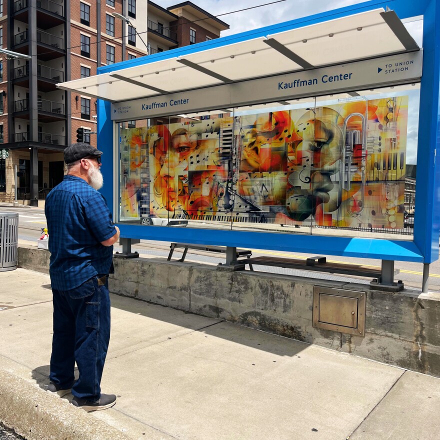 Morris checks out his digital collage installed in late May at the Kauffman Center streetcar stop.