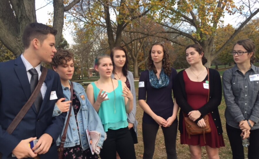A group of students and their teacher standing outside the Humanity Summit at Illinois Wesleyan University