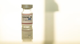 A vial labeled COVID 19 vaccine