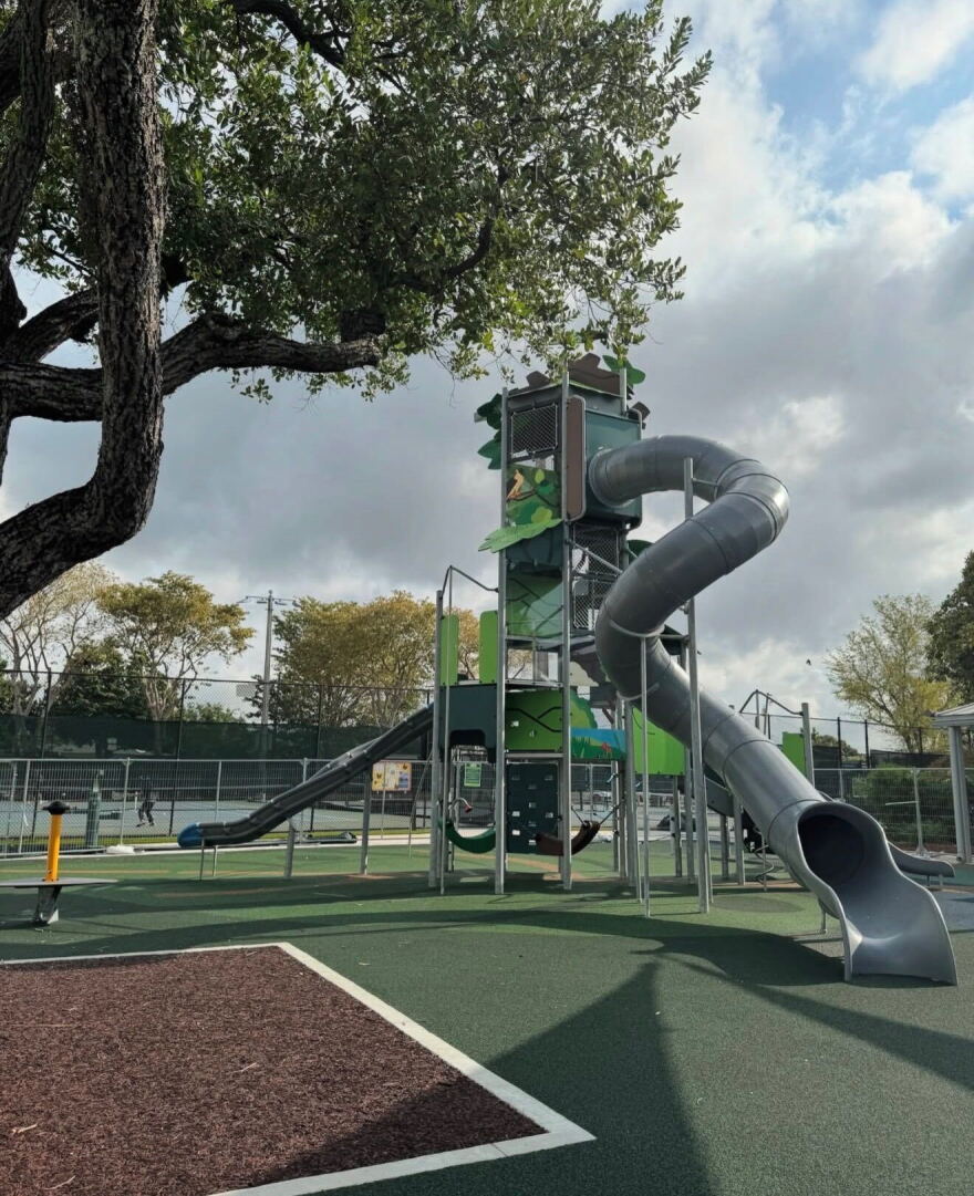 Image of an enclosed gray tube slide at a playground