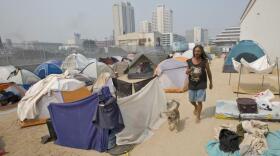 Robert Scott Cook, originally from Alaska, walks his dog Tramp through the tent city that sprang up next to the homeless shelter in downtown Reno, Nev., Wednesday, June 25, 2008. The tent city that sprang up during the recession may be gone but there are still homeless in need of help in Reno.