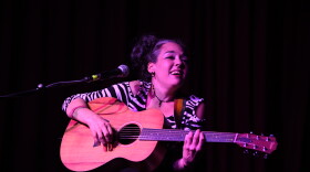 Tracy Marie plays guitar and sings on stage