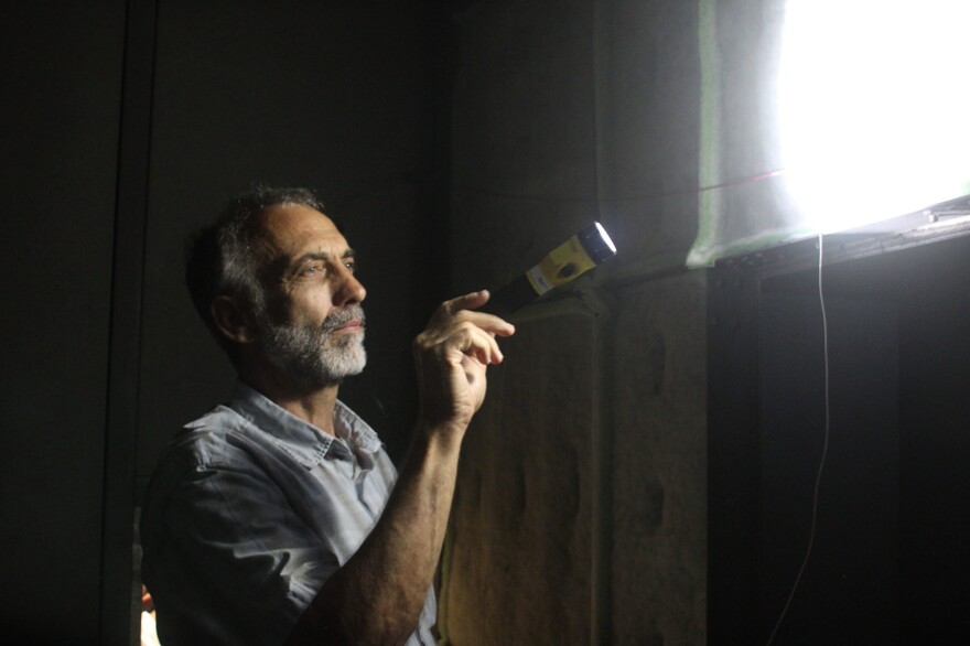 John Deffenbaugh, an engineer in Penn State's Office of the Physical Plant, checks the air-handling system in one of the university's buildings. It's one key to reducing energy use and greenhouse emissions. [Dan Charles]