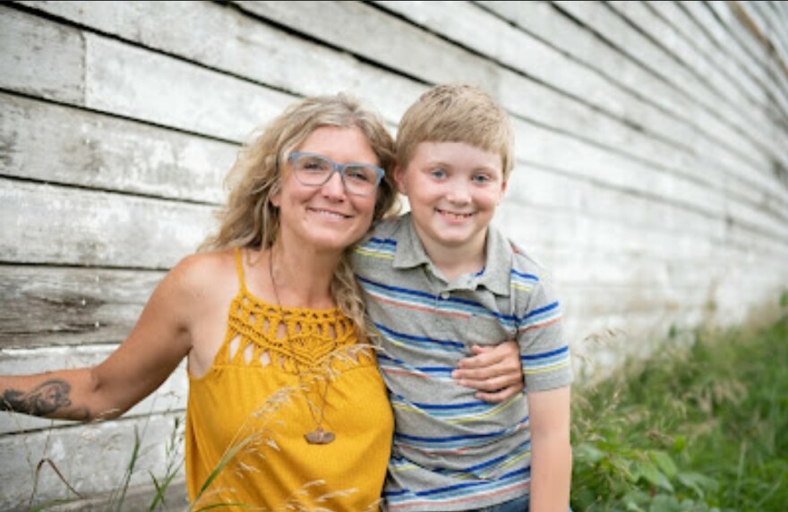 Patresa Hartman smiles with her son.