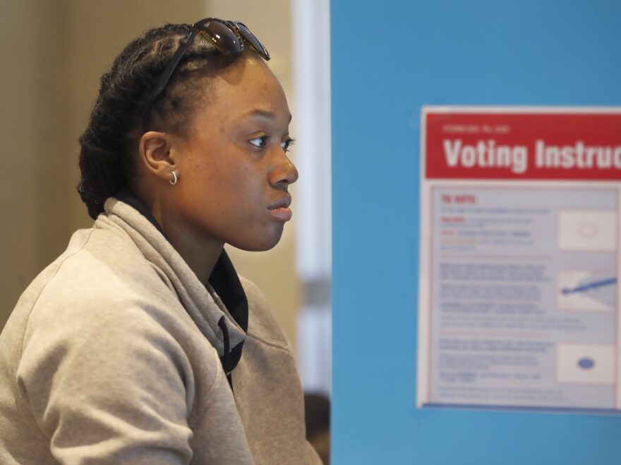 Aadilah Siddeeq votes using an electronic voting machine at a polling place in the Bronzeville neighborhood of Chicago in the Illinois primary.