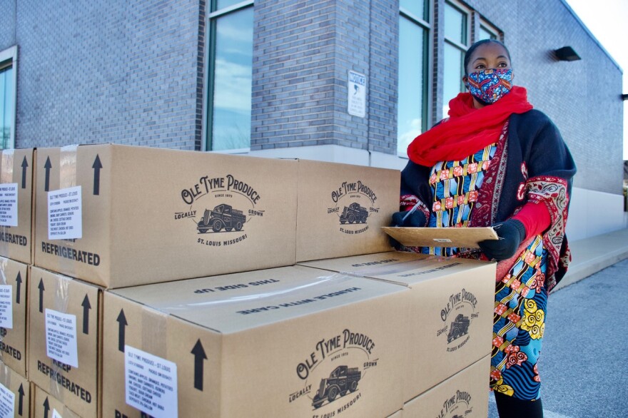 Kim Daniel keeps track of food being distributed to residents during a food drive Friday, Feb. 5. at the Flance Early Learning Center.