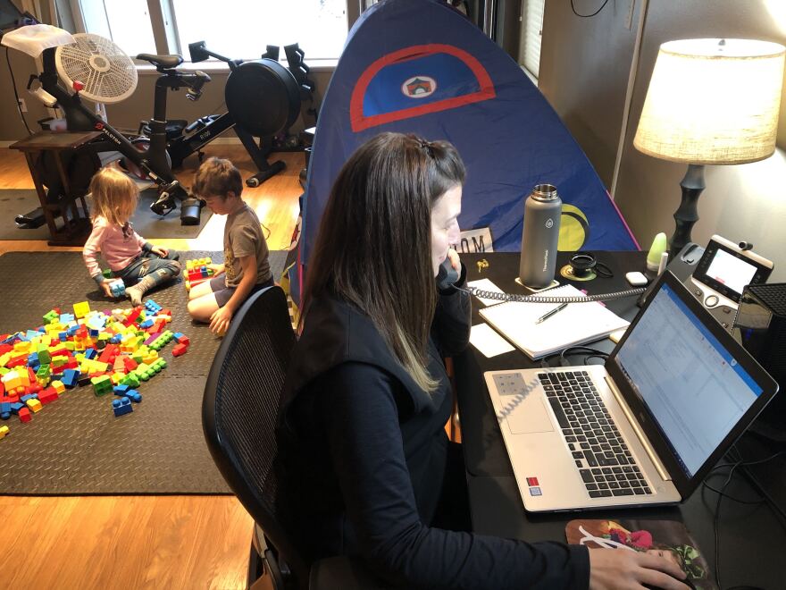 Northrim Chief Administration Officer Amber Zins works from a desk in the lower level of her South Anchorage home. She says her children sometimes crash her teleconferences. (Photo by Ryan Zins)
