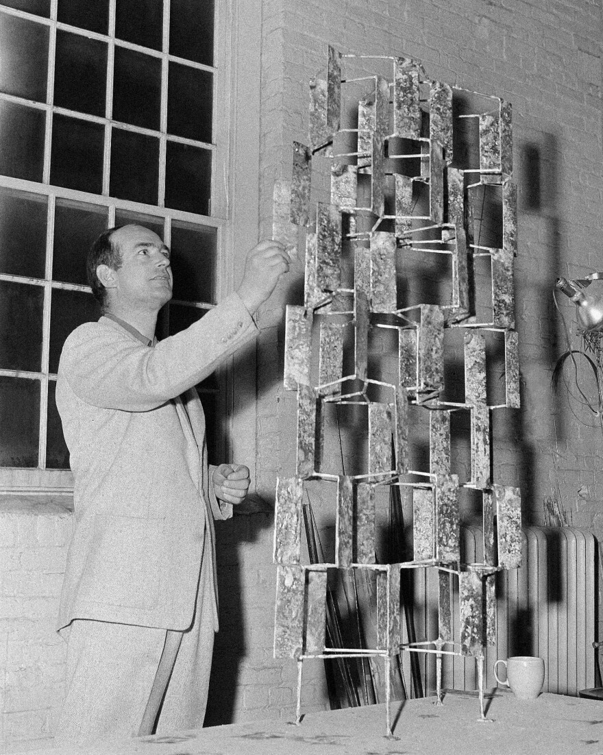 Bertoia looks at one of his art pieces at his studio in Barto, Pa., in May 1956.