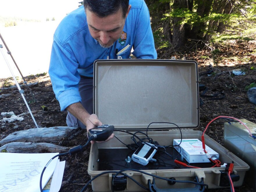 Researcher Chris Wayne sets up recording equipment at Crater Lake.
